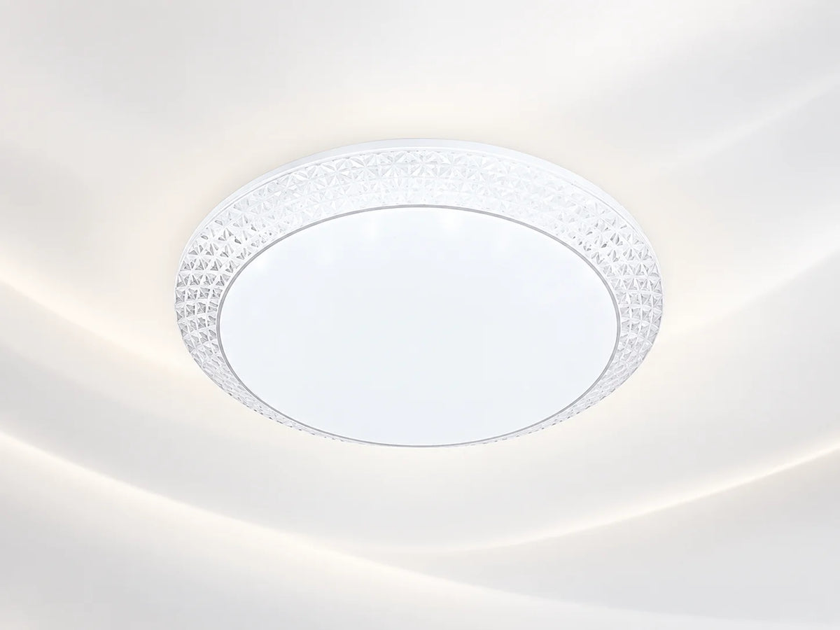 גוף תאורה צמוד תקרה עגול MOON CCT, בגימור לבן עם מסגרת דקורטיבית שקופה.