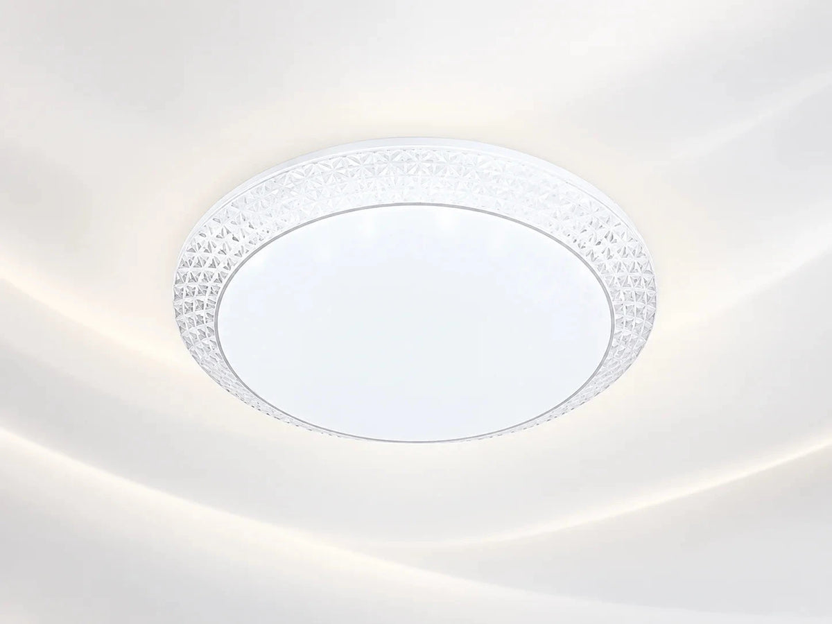 גוף תאורה צמוד תקרה עגול MOON CCT, בגימור לבן עם מסגרת דקורטיבית שקופה.
