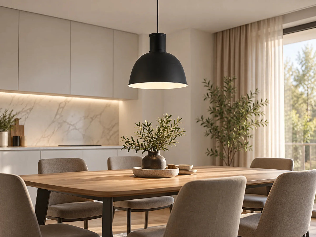 מנורת תלייה דקורטיבית MONOLI שחורה עגולה מותקנת מעל שולחן אוכל במטבח.